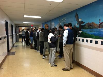 Students standing in two rows in the hallway