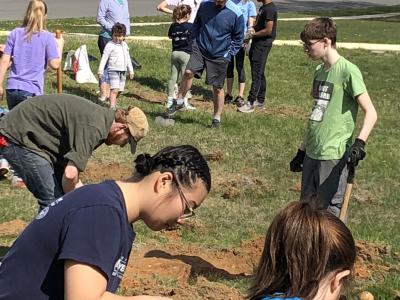 students digging holes for trees